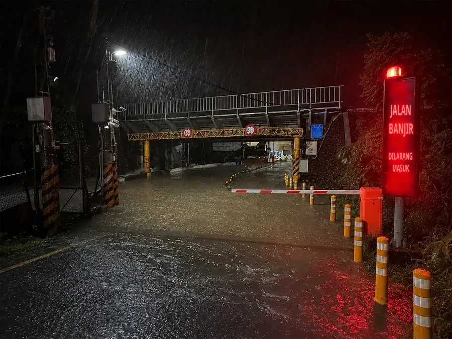 Peringatan penutupan pintu masuk underpass saat banjir, dengan lampu peringatan dan papan tanda untuk mencegah kendaraan masuk